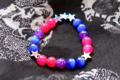 Bisexual/Biromantic pride flag star beaded gemstone bracelet. The beads are the bi flag colors (pink, purple, blue) and holographic stars. ♥ Bracelet Size: - To find the size that fits you best, you can measure the circumference around your wrist; for a comfort/loose fit, add 2cm to that measurement ♥ Handcrafted With: ✔ High-quality gemstone beads ✔ Durable stretchy cord Thank you for visiting! If you have any questions, feel free to contact me!  Instagram: @FrogsMakingToast Multicolor Star-shaped Beaded Bracelets For Friendship, Bi Bracelet, Bisexual Bracelet, Lgbtq Bracelet, Lgbtq Gifts, Bi Flag, Stretchy Beaded Bracelet, Pride Bracelet, Tattoo Bracelet