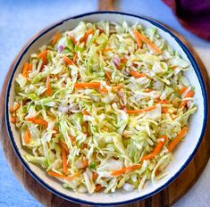 a bowl filled with coleslaw and carrots