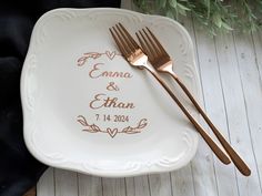 a couple of forks sitting on top of a white plate