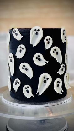 a black and white cake decorated with ghost faces