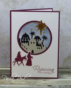 a christmas card with a nativity scene in the middle and a star on top