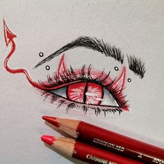 a pencil drawing of an eye with red lipstick on it and two other colored pencils next to it