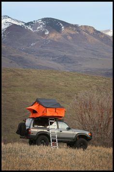 a truck with an orange tent on the roof