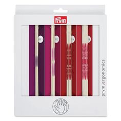 five different colored chopsticks in a white box with red, purple and yellow designs