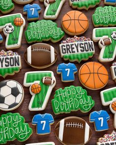 decorated cookies with sports and numbers are displayed on a wooden table for a birthday party