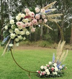 a circular floral arrangement in the middle of a field