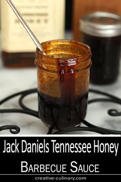 jack daniels tennessee honey barbecue sauce in a glass jar with a spoon sticking out of it