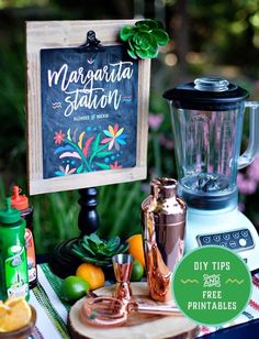 there is a sign that says margarita station on the table next to some fruit and drinks