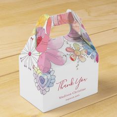 a thank you baby shower gift bag with flowers on it and the words, thank you baby shower