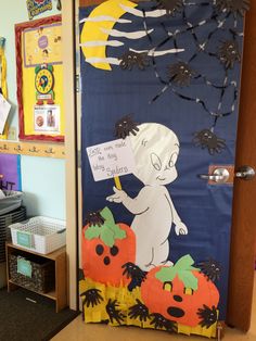 a classroom door decorated for halloween with an image of a ghost and pumpkins on it