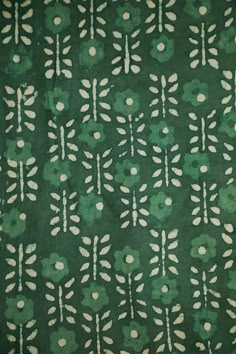 a green background with white flowers and leaves