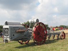 an old fashioned farm equipment on display in a field