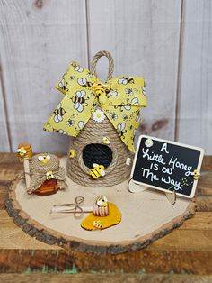 a beehive with a yellow bow on top of it and some other items