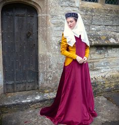 Ladies would often dress up there kirtle by wearing and surcoat over the top which could be styled simply or made lavishly with fur trims and fancy fabric. We offer a simple style surcoat with a low hanging side openings which is made from your chosen coloured duchess poly Velvet fabric colours in the pictures . The inside is lined in a cream cotton fabric for comfort and structure.  We will need your hip size and shoulder to shoulder measurements as well as you shoulder to floor measurements ( Vintage Medieval Dress For Larp With Historical Design, Regency Style Long Sleeve Medieval Costume Dress, Regency Style Medieval Costume Dress With Historical Design, Medieval Costume Dress With Historical Design, Historical Costume For Medieval Festivals With Historical Design, Regency Style Medieval Dress For Larp, Regency Style Medieval Dress For Larp And Festivals, Winter Medieval Dress For Larp With Historical Design, Historical Costume For Medieval Festivals