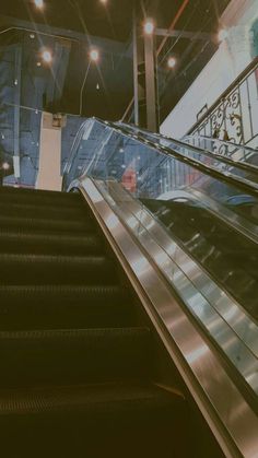 an escalator in a building with people on it