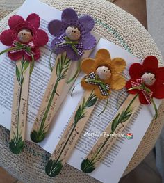 four flower hair pins on top of an open book