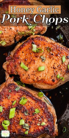 two pork chops with green onions and seasoning on top in a skillet