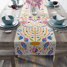 the table is set with plates, cups and napkins for hanukkah