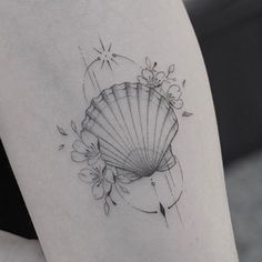 a woman's thigh with a fan tattoo on it