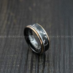 a black and gold wedding band with white deer on it