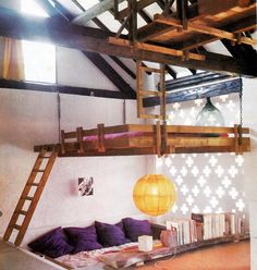 a loft bed is in the middle of a room with bookshelves and ladders