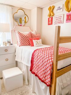 a bedroom with white and red bedding and gold accents on the headboard, along with a wooden ladder