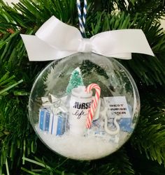 a christmas ornament hanging from a tree with candy canes and candies