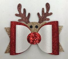 a red and white reindeer bow with glitter antlers on it's head is shown