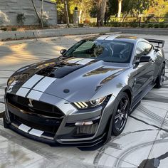 a silver sports car parked in a parking lot