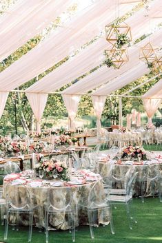 tables and chairs are set up under the tent for an outdoor wedding reception with white draping