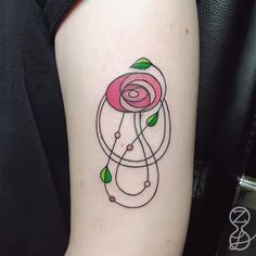 a woman's arm with a rose tattoo on it