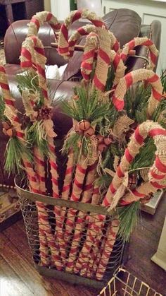 a basket filled with candy canes on top of a wooden table