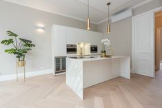 a kitchen with an island, stove and oven in the middle of it is shown