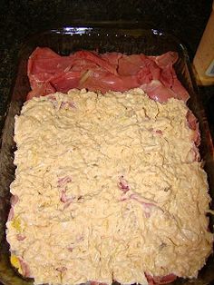 meat and cheese in a casserole dish ready to be baked into the oven