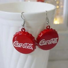 the coca cola bottle earrings are red and white