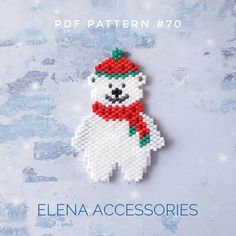 a cross stitch polar bear ornament with a red scarf on it's neck