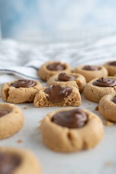 peanut butter and chocolate chip cookies on a baking sheet with a spoon in the background