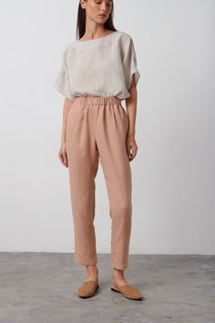 "RAVEN is a high waisted linen pants. DETAILS - High waisted - Seam pockets - Tapered leg - Elasticated waist - 100% lightweight European linen fabric - Cut and sewn to order just for you in our studio COLOR - Camel, you can also choose other colors above - Fabric samples are available here https://www.etsy.com/listing/586569696/linen-fabric-samples SIZING & FIT - Fits true to size - Waist (laid flat) is approximately 24 inches / 61 cm  - Hips is approximately 40.5 inches / 102 cm  - Inseam is approximately 29 inches / 73 cm - Measurements taken from a size XS - Model is 5'9.5\" / 177cm and wearing a size XS CARE FOR LINEN - Machine wash up to 30ºC/86ºF gentle cycle - Lay flat to dry or tumble dry low - Warm iron if needed - Do not bleach SIZE GUIDE Size conversion guide Size XS (US 0-2, I Beige Linen Bottoms With Elastic Waistband, High-waist Linen Bottoms In Neutral Color, Neutral Linen Pants With Elastic Waistband, Neutral High Waist Relaxed Fit Pants, Neutral High-waist Relaxed Fit Pants, High Waist Brown Linen Bottoms, Brown High Waist Linen Bottoms, Beige Linen Bottoms With Pockets, Beige Linen Pants With Elastic Waistband