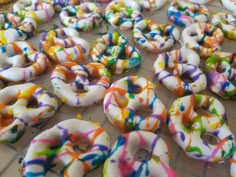 there are many donuts with sprinkles all over the place on the table