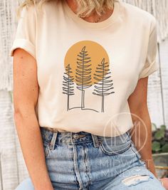 The perfect shirt for someone who loves the outdoors. Pine Tree T Shirt Forest Themed Shirt Camping Gift Shirt Adventure is Calling Sunset TShirt Wildlife Tee Wilderness Shirt Wisconsin Tee Bella Canvas 3001T:  T-Shirt Sizing Please reference the size chart before selecting shirt size.  Use one of your own t-shirts to measure the size and fit.  Then compare with the size chart provided to ensure an accurate fit. T-Shirt Materials 100% combed and ring-spun cotton. Heather colors are 90% combed an Trendy Tshirt Designs 2023, T Shirt Cricut Ideas, Nature T Shirt, Outdoor Tshirt Design, Camping T Shirts Ideas, Simple Graphic Tees, T Shirt Print Ideas, Outdoorsy Shirt, Adventure Shirts