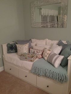 a white couch with pillows on it in a room