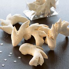 some white mushrooms are sitting on a table next to a bag of starbursts