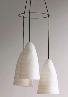 two white lamps hanging from a wire