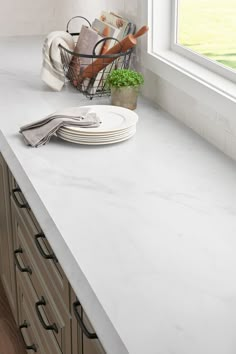 a kitchen counter with plates and utensils on it