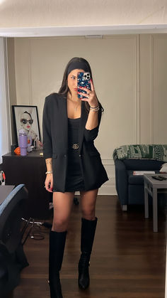 A stylish mirror selfie showcasing a chic fall outfit: a fitted black blazer paired with a black skirt, knee-high leather boots, and a women's Gucci belt, creating an all-black, sophisticated look perfect for the season. Knee High Black Boots Outfit Dressy, Outfits With Knee High Boots Black, High Boot Outfits, High Black Boots Outfit, Belted Skirt Outfits, Black Knee High Boots Outfit, Skirt And Knee High Boots, Skirts And Boots, Gucci Belt Outfit