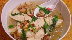 a bowl of soup with mushrooms and spinach