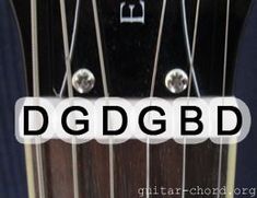 an acoustic guitar neck with the dgdgbdb logo on it's left side