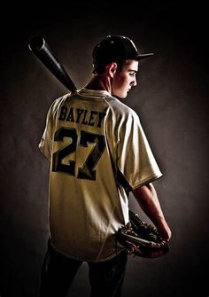 a baseball player holding a bat and wearing a jersey with the number 27 on it