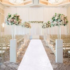 the aisle is lined with white and pink flowers