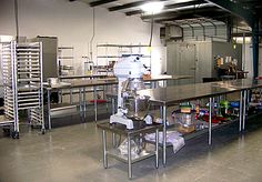 an industrial kitchen with stainless steel counters and appliances